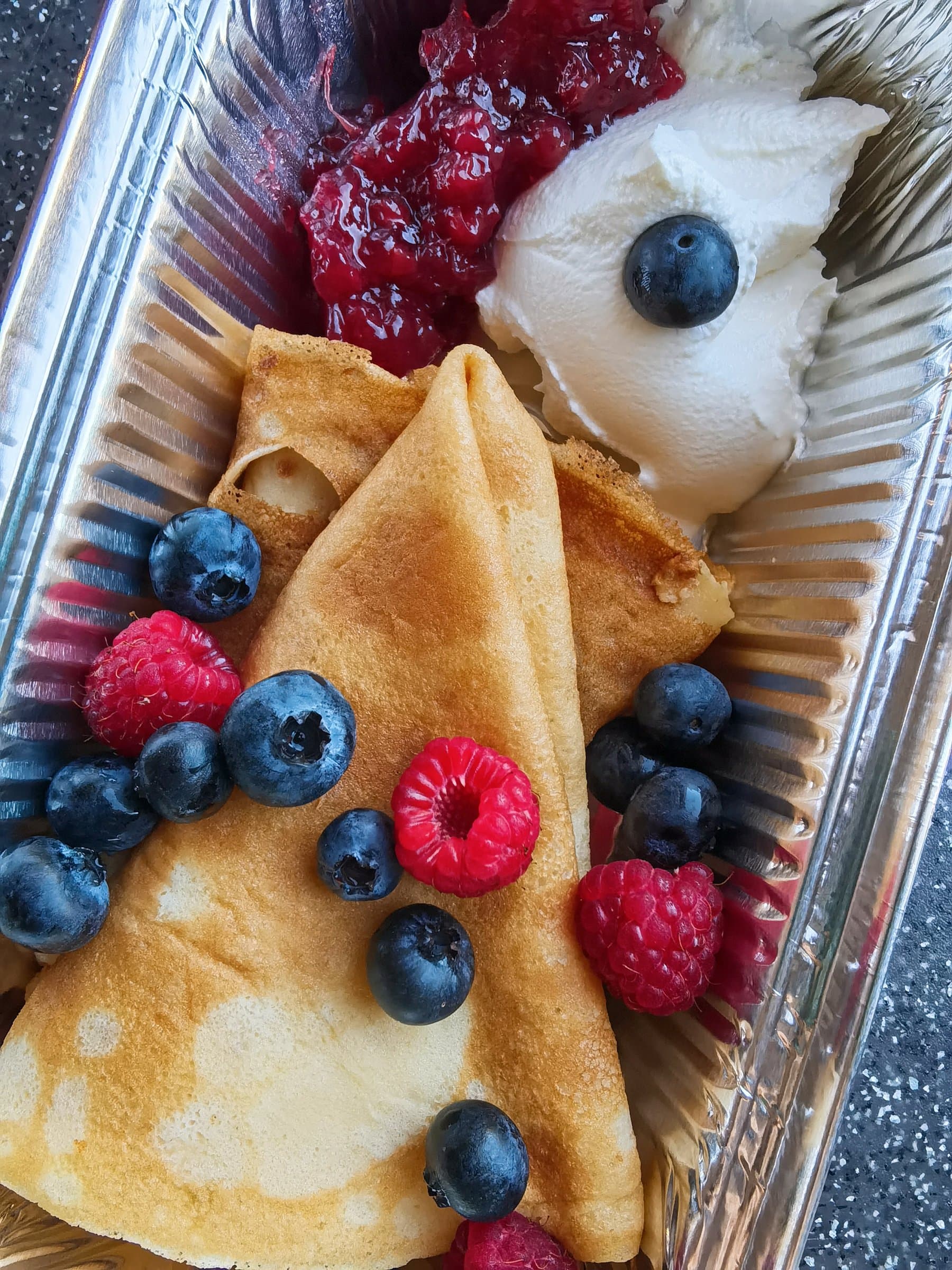 A second tray of crepes with mixed berries and whipped cream from a Wayfarer Zuevcheff cooking session